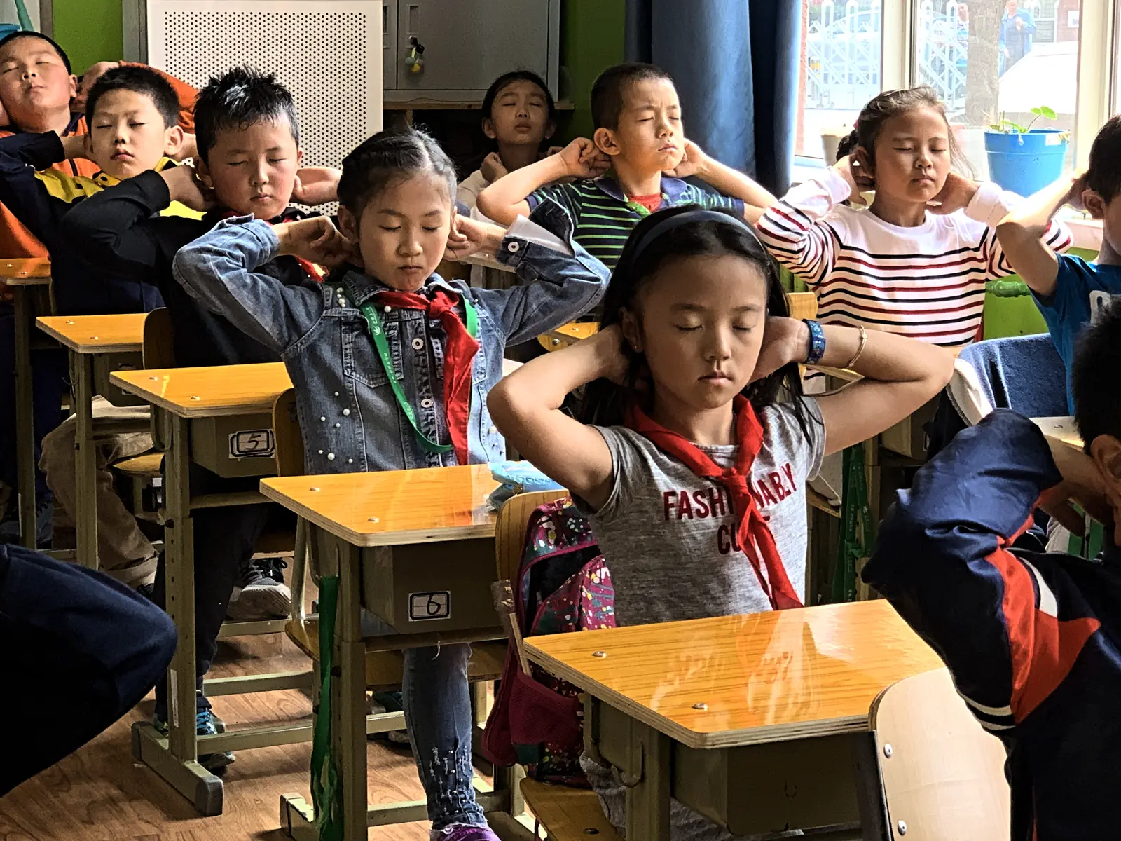 Children at their desks during the daily in-class exercise routine