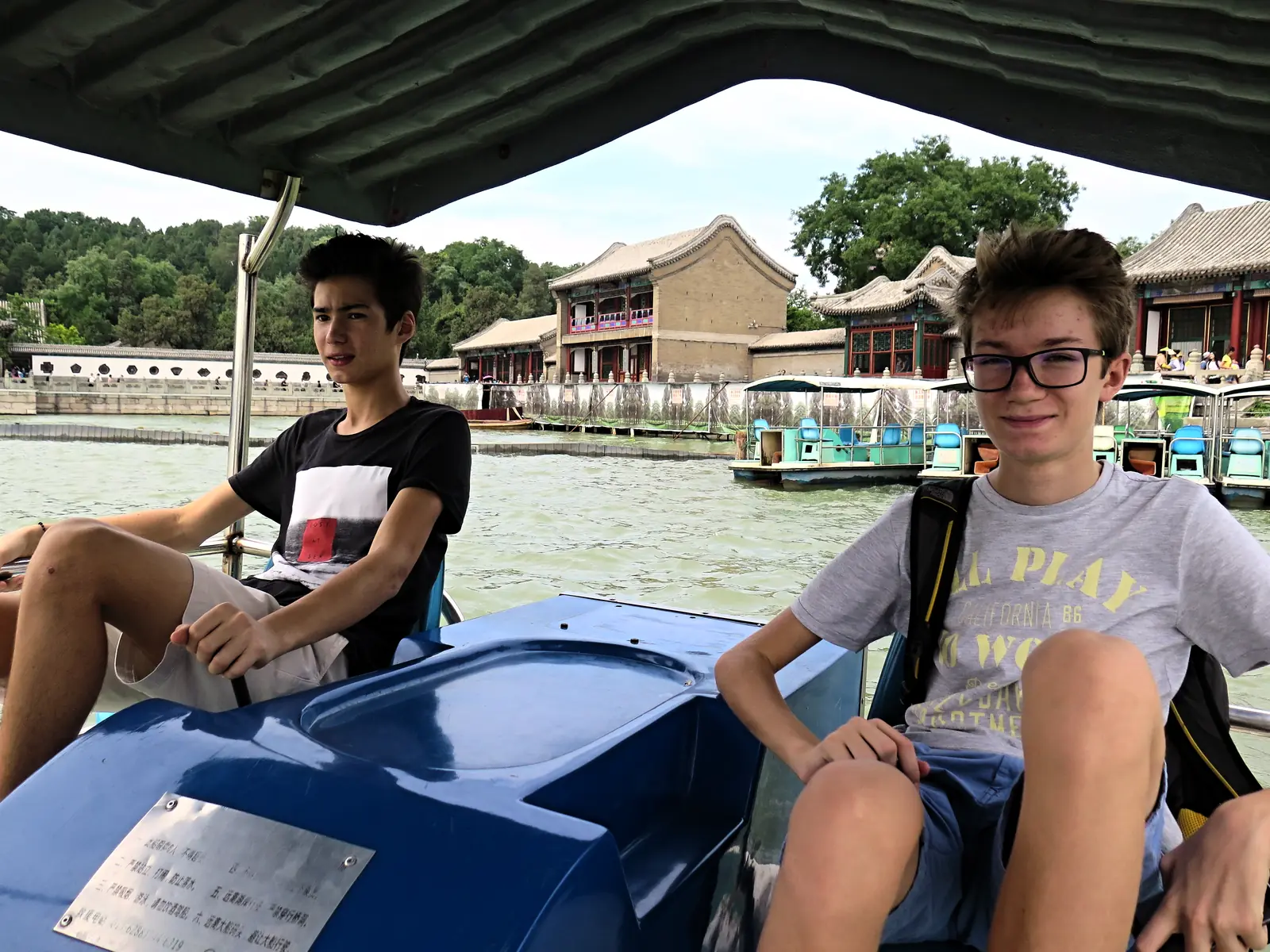 Two campers on a boat crossing Kunming Lake at the Summer Palace