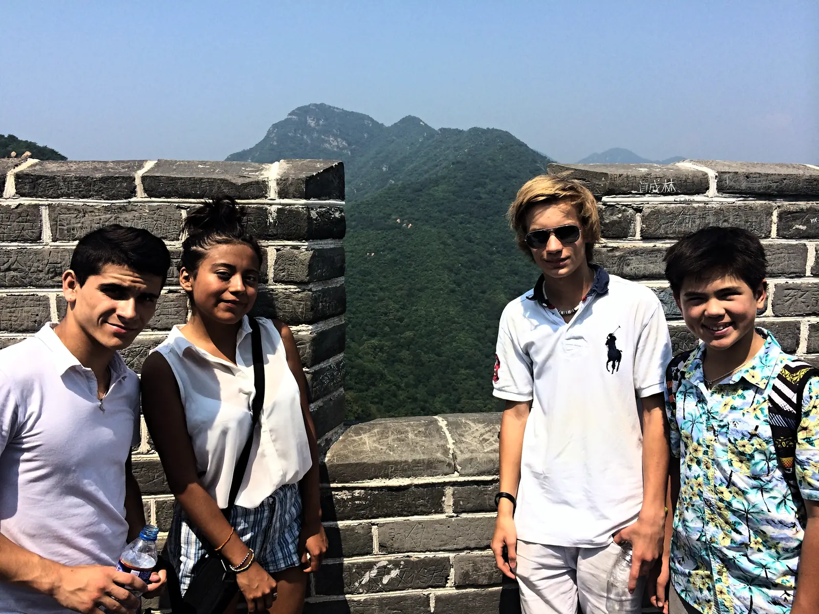 Campers on the ramparts of the Great Wall with mountains in the distance