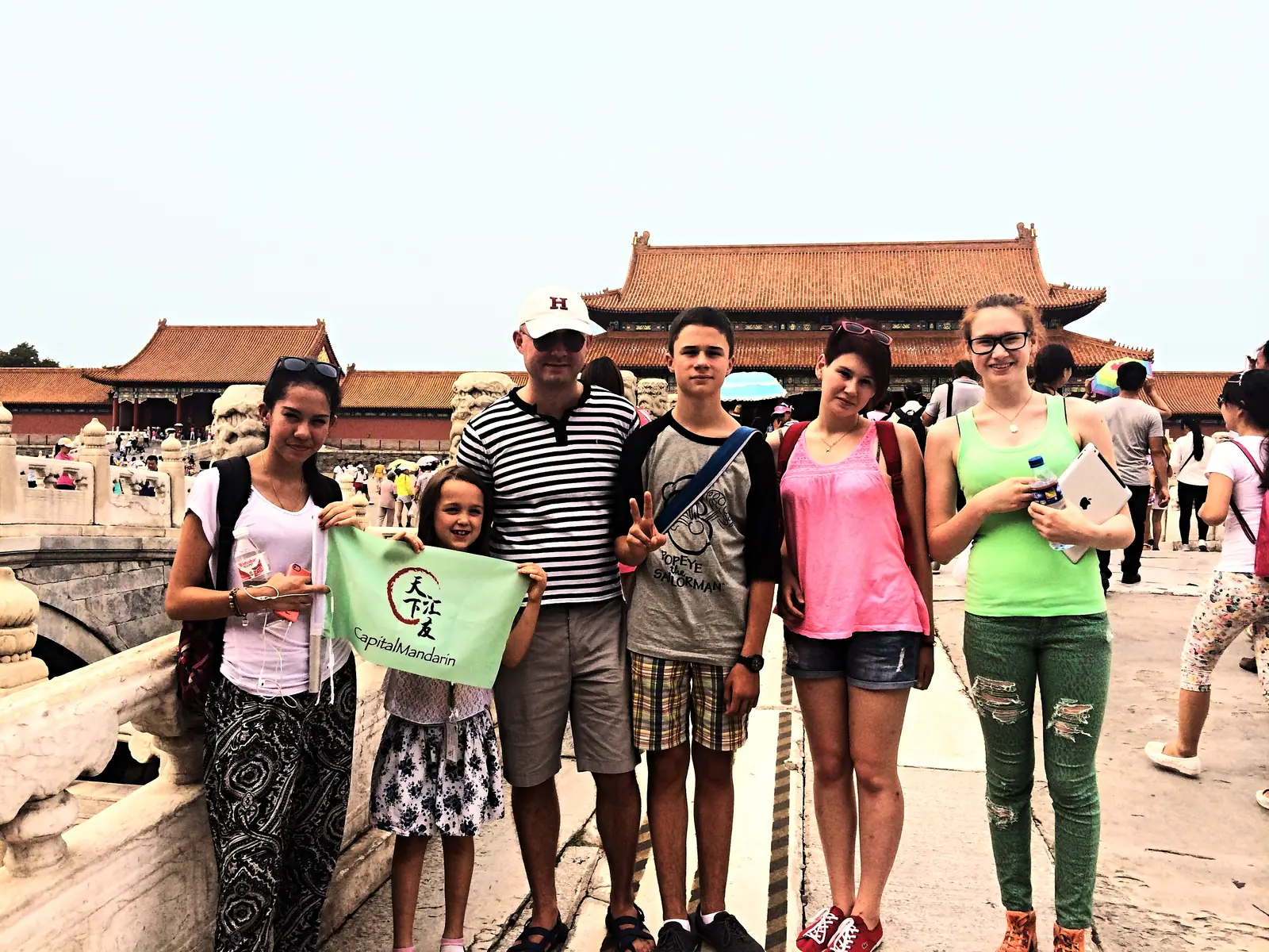 The camp group with the school flag on a bridge at the Summer Palace