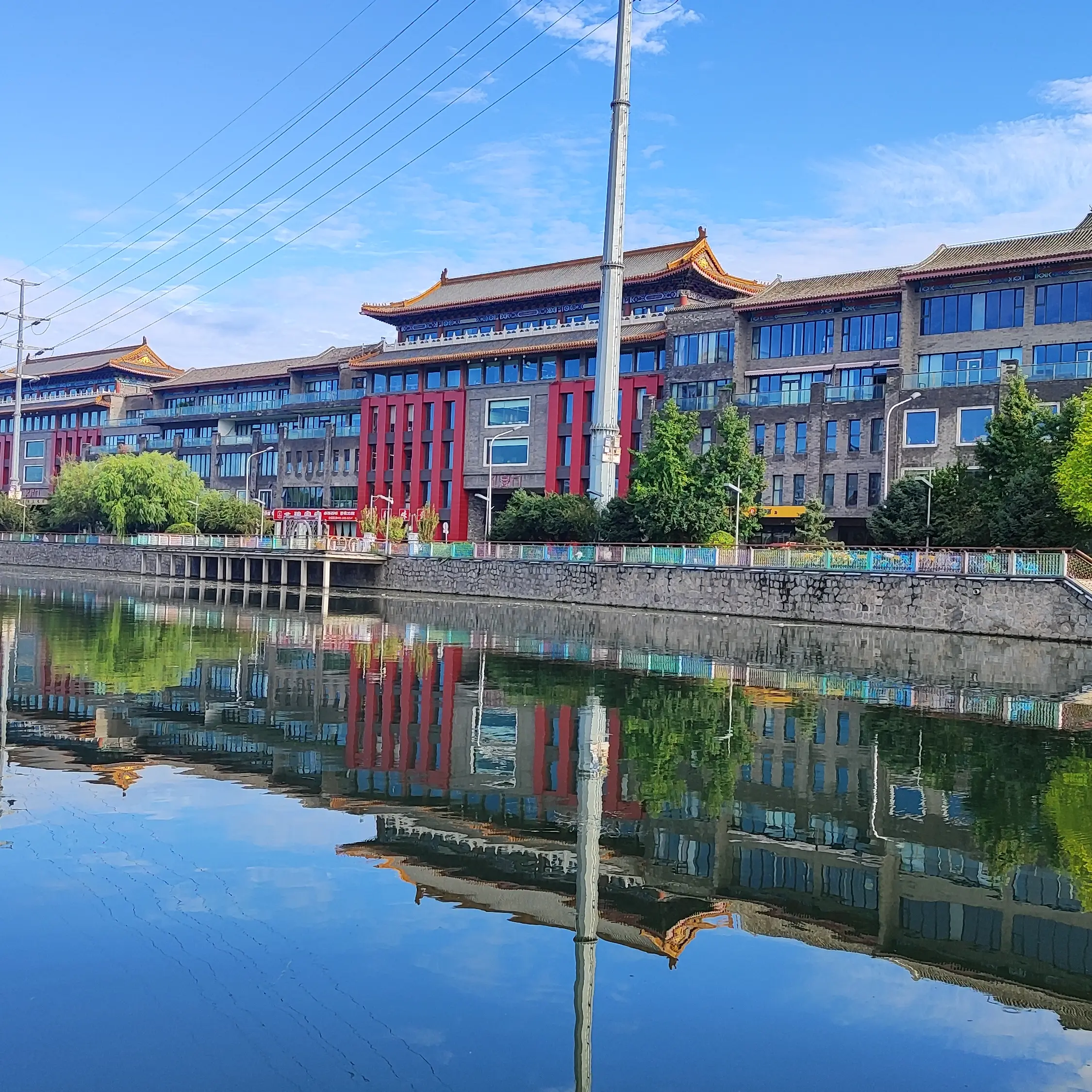 A quiet hutong in Gaobeidian village with blue-brick, grey-tile buildings lining the alley