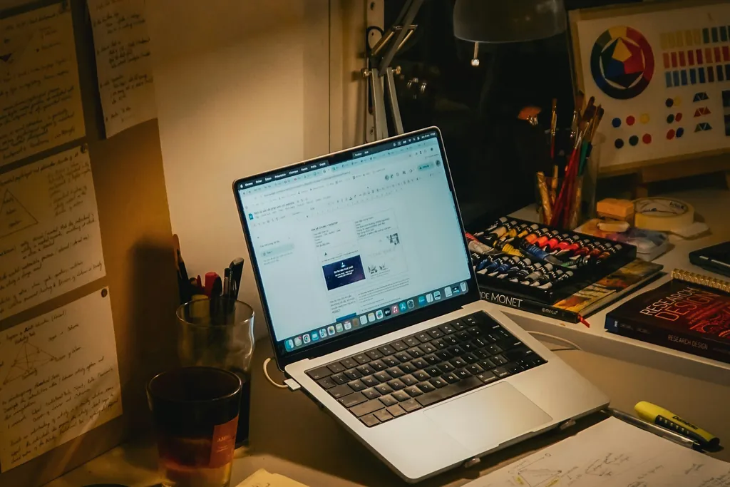 A lamplit desk with a laptop, books and papers at night — placeholder for a photo of a teen student in an AP Chinese lesson