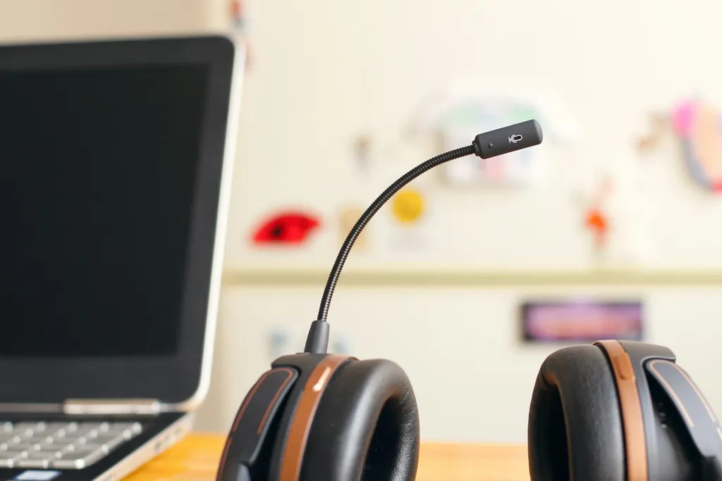 A headset resting beside a laptop, set up for recorded speaking practice — placeholder for a photo of a student doing recorded HSKK speaking practice