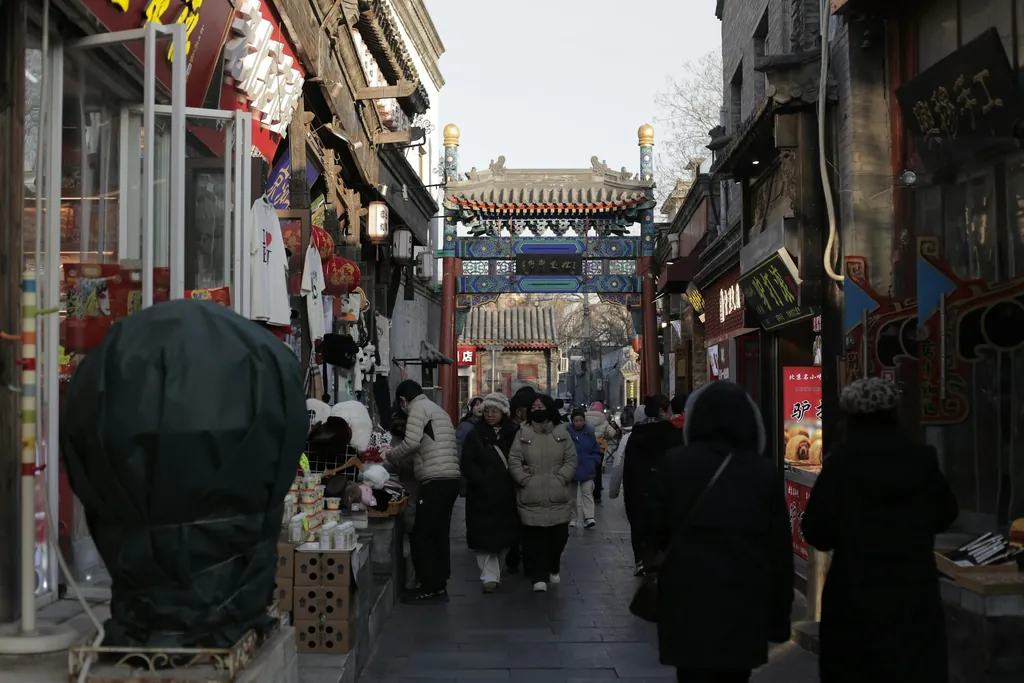 A busy Beijing shopping street lined with shopfronts and pedestrians — placeholder for a photo of a student speaking with a teacher or ordering at a Beijing street stall